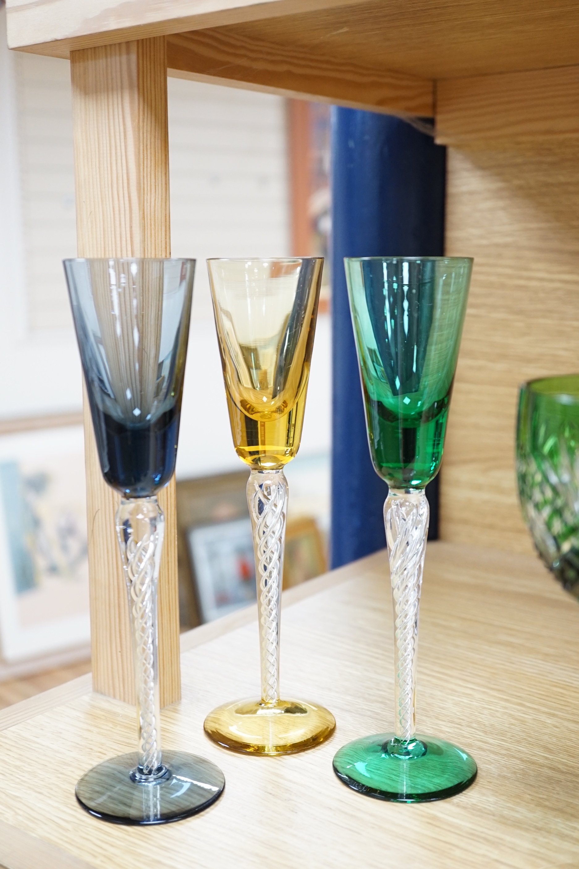 Two sets of six Harlequin colour flashed hock glasses and a set of four air twist glasses